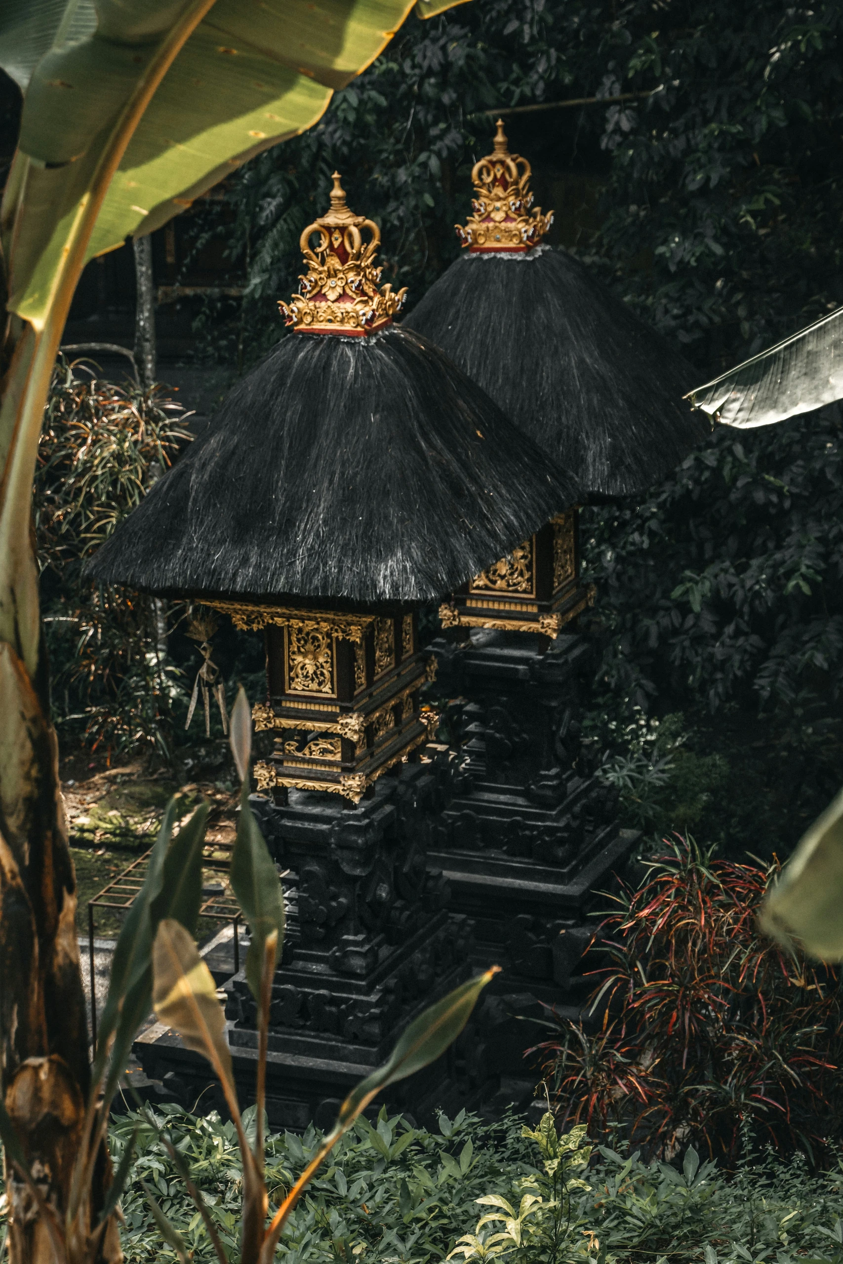 Balinese shrines standing among dense greenery