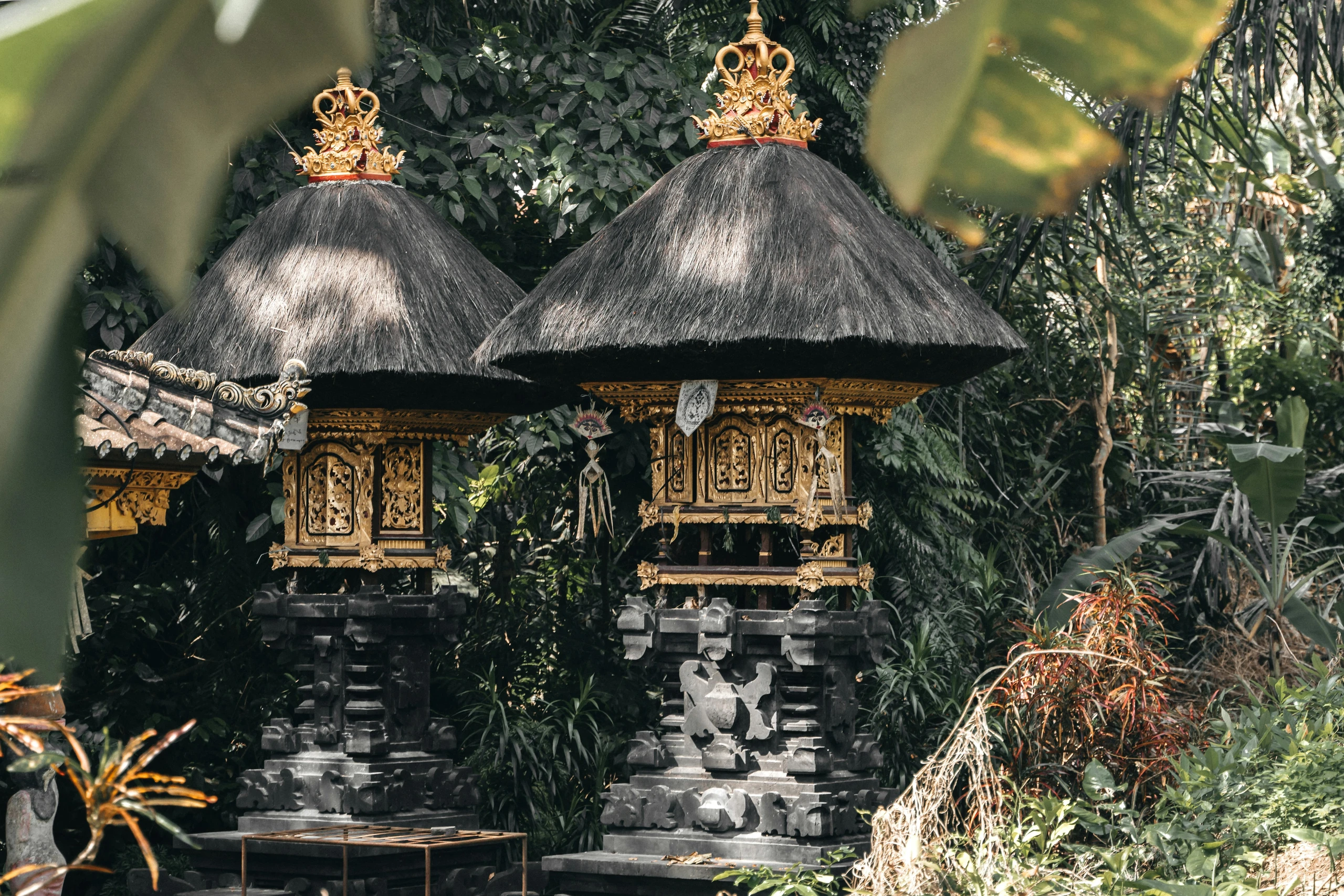 Balinese shrines standing among dense greenery